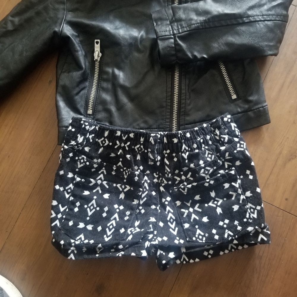Black jacket with black and white shorts
